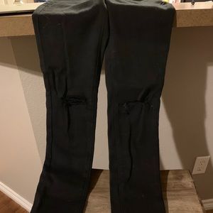 Skinny black KanCan jeans with knee slits